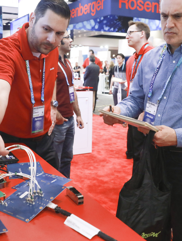 An exhibitor showing his product to an attendee