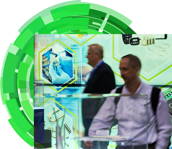 Two attendees examining products in the expo hall floor