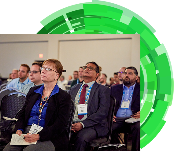 Attendees listening to conference